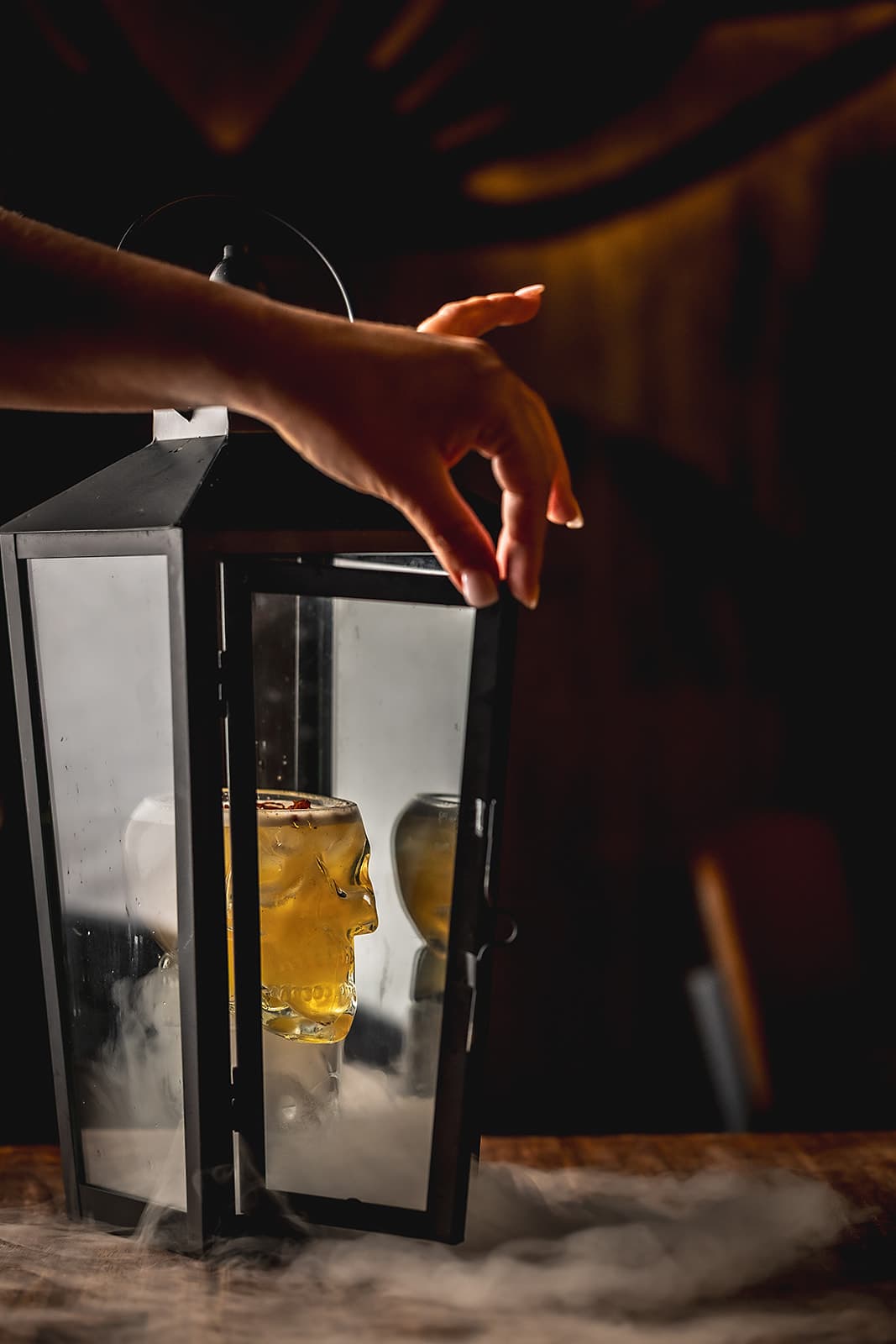 Calavera cocktail presented in a lantern