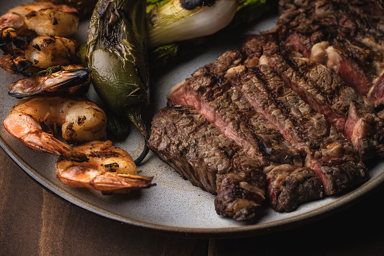 Surf and turf with sliced steak, shrimp and vegetables