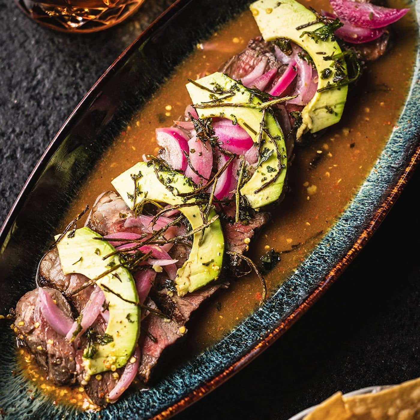 Sliced ribeye with avocado and pickled onions at Miel de Agave